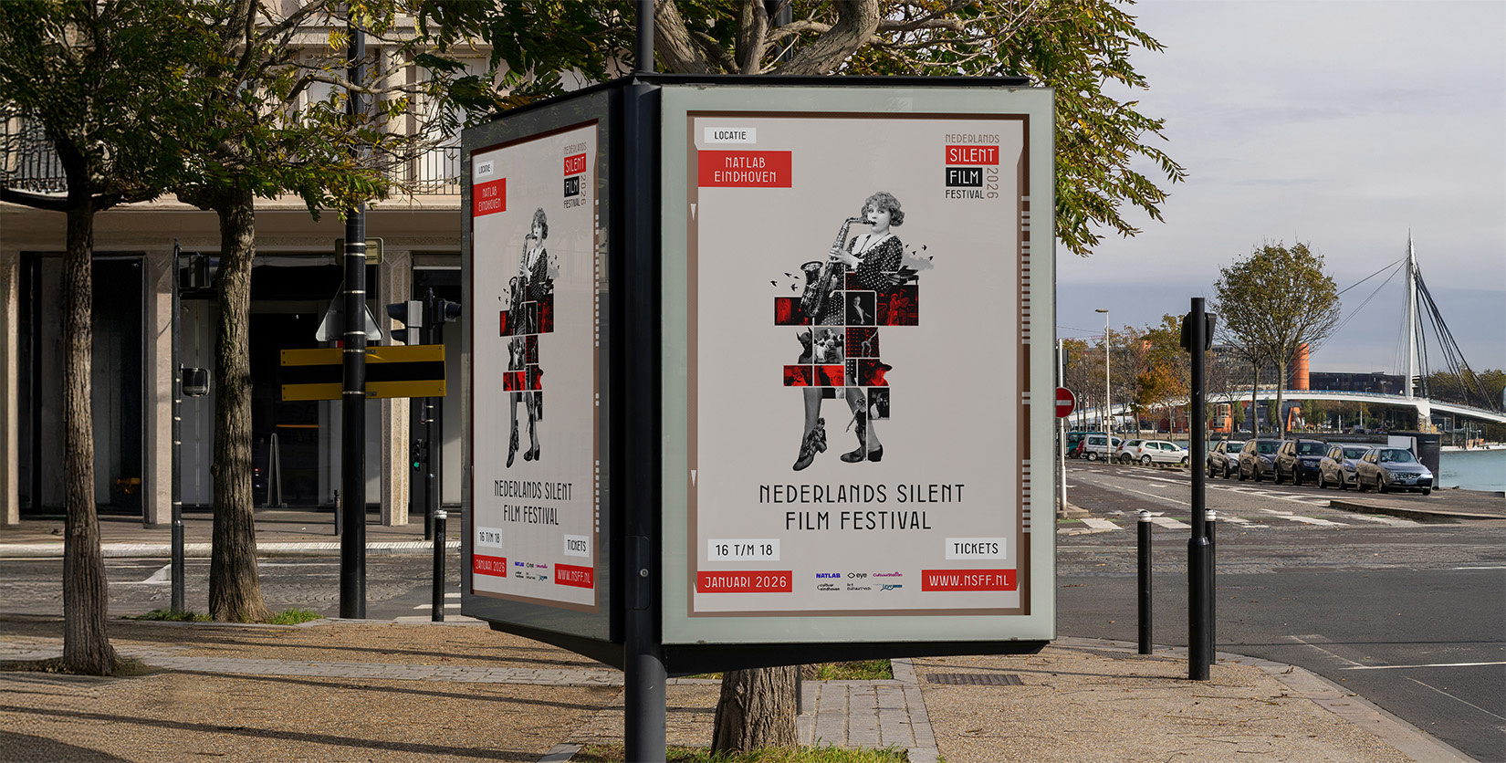 Poster display on a city square advertising the Nederlands Silent Film Festival, with a red-toned illustration of a person