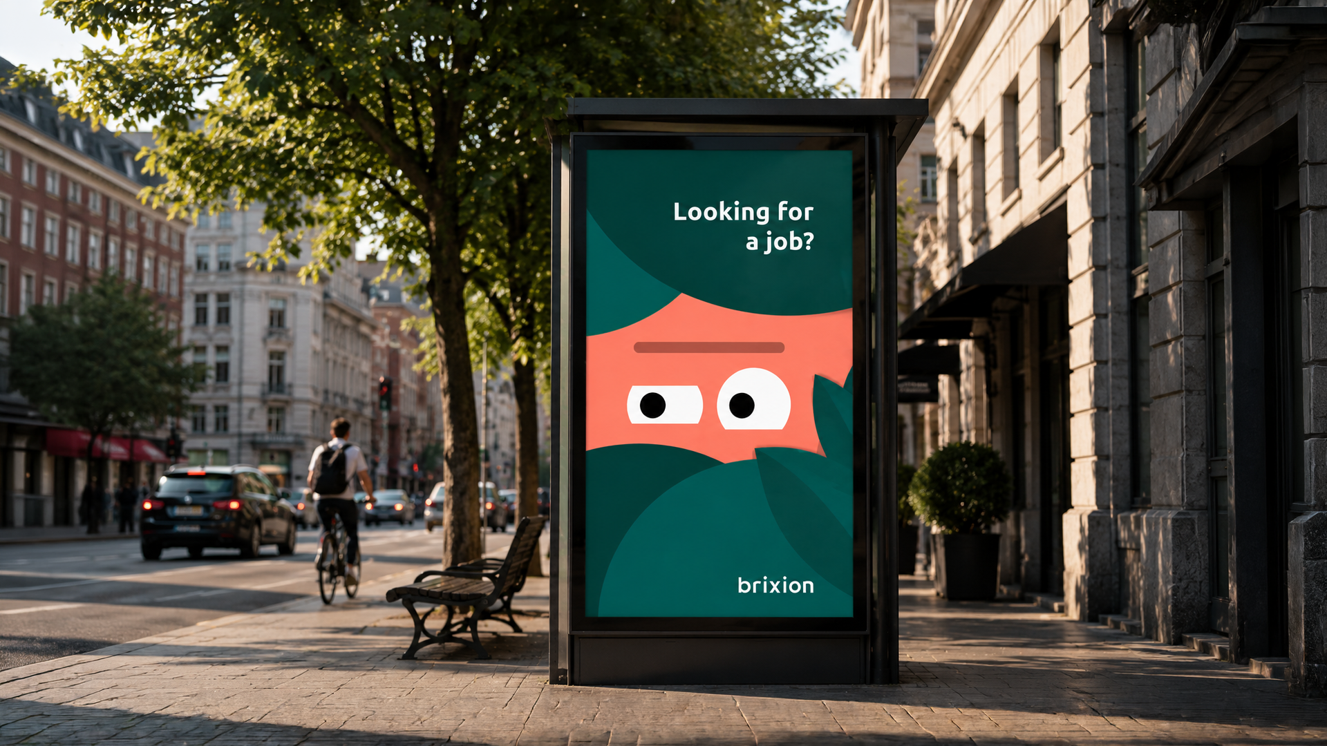 Bus shelter billboard on a city street displaying a Brixion ad with the headline 'Looking for a job?'